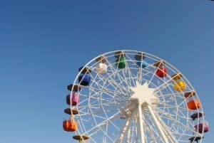 Multi-colored ferris wheel against a clear blue sky