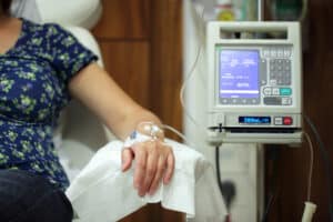 Woman receiving medication through IV in her arm