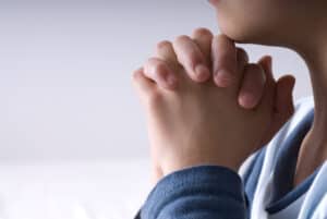 Hands clasped in prayer