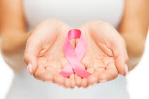 Woman holding a pink breast cancer ribbon
