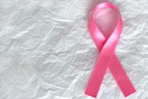 Pink breast cancer ribbon on white background