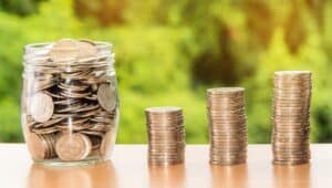 Jar of coins and two stacks of coins