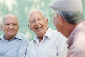 Three elderly men talking with each other