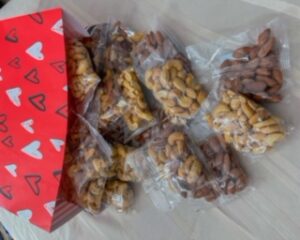 Valentine gift bag with mixed nuts spilling out.