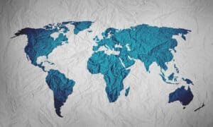 Image of blue world map on gray background.