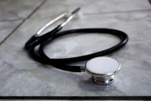 Image of black stethoscope on marble table.