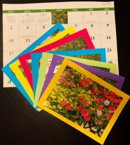 Image of seven multi-colored greeting cards lying on a page from a calendar.