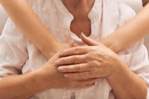 Image of young and older women hugging.
